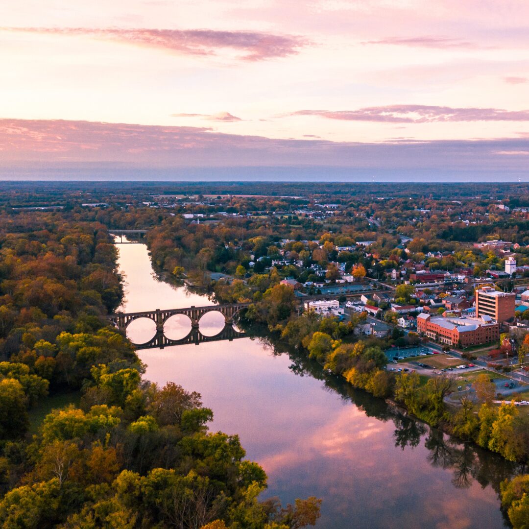 Virginia sunset over river, trees, city