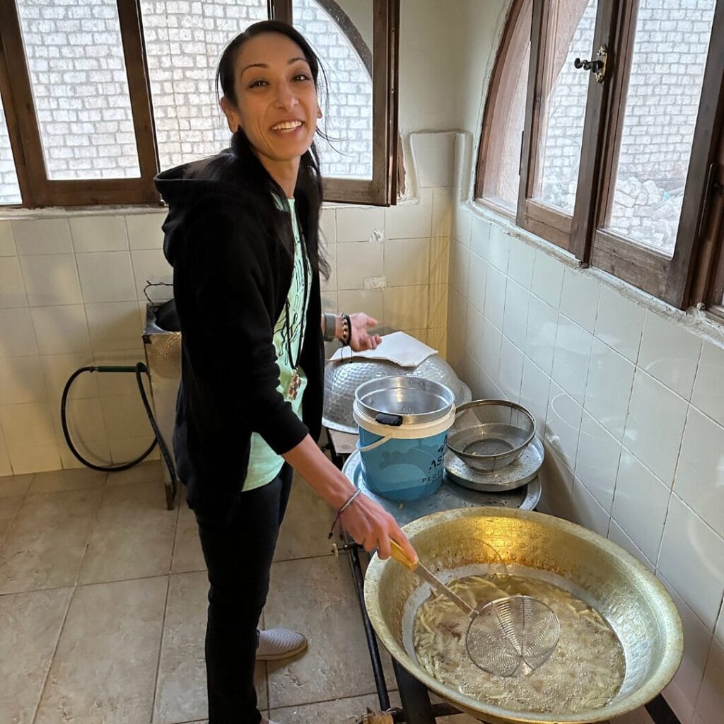 Dr. Christine Rizkalla cooks food during her volunteering trip