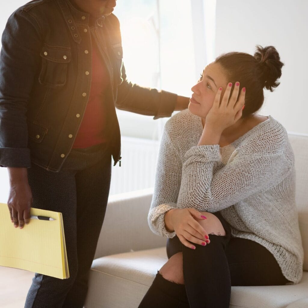 A therapist consoling a patient